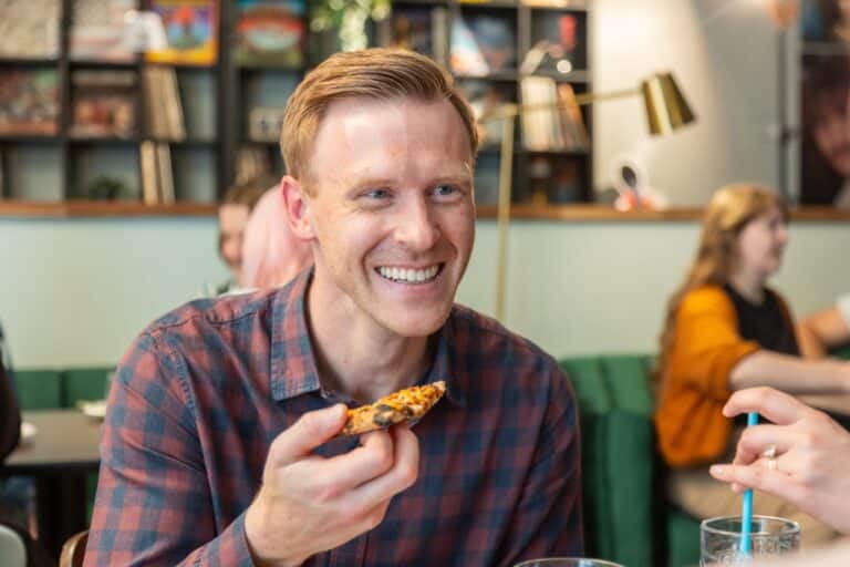 A man enjoying a pizza