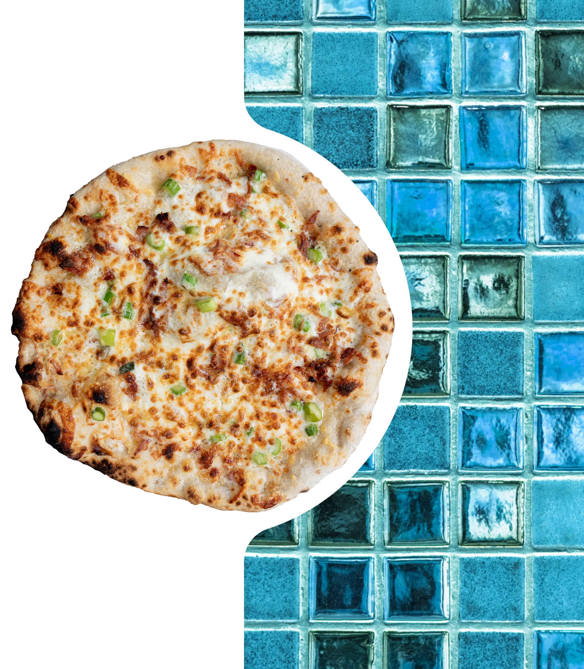 Pizza next to a blue mosaic tile