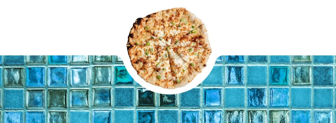 Pizza next to a blue mosaic tile